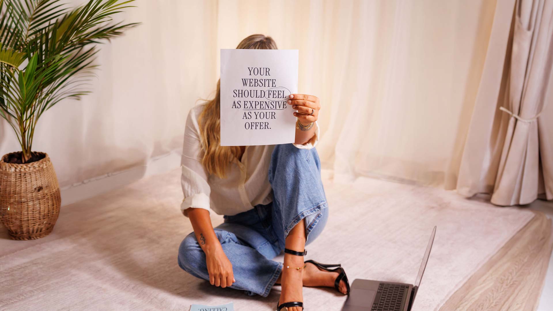 Arise-design-co-holding-paper-up-saying-why-luxury-websites-is-importnat